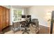 Bright home office with large window, hardwood floors and desk setup, great for remote work at 5609 Barham Ct, Raleigh, NC 27613