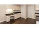 Kitchen features white cabinets, black countertops, stainless appliances, and hardwood floors at 5609 Barham Ct, Raleigh, NC 27613