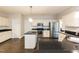 This updated kitchen features stainless appliances, an island, and white cabinets at 5609 Barham Ct, Raleigh, NC 27613