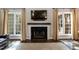Bright living room showcasing a fireplace with wooden mantle and abundant natural light at 5609 Barham Ct, Raleigh, NC 27613