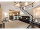 Open-concept living room featuring hardwood floors, a staircase, and plenty of seating at 5609 Barham Ct, Raleigh, NC 27613