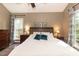 Bright main bedroom with hardwood floors, neutral decor, and a ceiling fan at 5609 Barham Ct, Raleigh, NC 27613