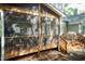Inviting screened porch with wood frame, railing, and steps leading to the backyard at 5609 Barham Ct, Raleigh, NC 27613