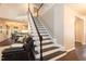 Open staircase leading to upper level with dark wood flooring at 5609 Barham Ct, Raleigh, NC 27613