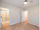 Bedroom featuring a ceiling fan, wood floors, and an en suite bathroom at 6 1St St, Franklinton, NC 27525
