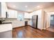 Updated kitchen with white cabinets, stainless steel appliances, and dark hardwood floors at 6 1St St, Franklinton, NC 27525
