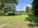 Backyard with view, showing ample green space and beautiful landscaping at 6 First St, Franklinton, NC 27525
