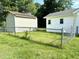 Fenced backyard, showing the exterior of the home and the detached garage at 6 First St, Franklinton, NC 27525