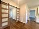 A home interior with beautiful wood floors and unique, partially-frosted sliding barn doors between rooms at 6 First St, Franklinton, NC 27525