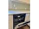 Kitchen with white cabinets, stylish backsplash, and stainless steel dishwasher with the door open at 6 First St, Franklinton, NC 27525