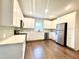Modern kitchen boasting white cabinets, stainless steel appliances, and stylish backsplash at 6 First St, Franklinton, NC 27525