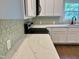 Stylish kitchen showcasing white cabinets, sleek countertops, modern backsplash and stainless steel appliances at 6 First St, Franklinton, NC 27525