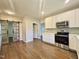 Well-lit kitchen with stainless steel appliances, white cabinetry, and a convenient sliding door at 6 First St, Franklinton, NC 27525