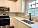 Bright kitchen featuring stainless steel appliances, modern backsplash, and ample counter space at 6 First St, Franklinton, NC 27525