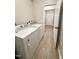 Laundry room with updated washer and dryer, neutral walls, and access to front door at 6 First St, Franklinton, NC 27525