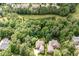Aerial view of a home nestled amongst lush trees in a beautiful neighborhood at 605 Bear Tree Crk, Chapel Hill, NC 27517