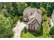 Overhead view of a home with well-kept landscaping and a long driveway surrounded by trees at 605 Bear Tree Crk, Chapel Hill, NC 27517