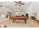 Spacious basement featuring a pool table and seating area under fan lighting at 605 Bear Tree Crk, Chapel Hill, NC 27517