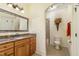 Bathroom with granite counters, mosaic mirror, and adjacent toilet and shower at 605 Bear Tree Crk, Chapel Hill, NC 27517