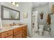 Neutral-toned bathroom features granite counters, framed mirror, and shower-tub combination at 605 Bear Tree Crk, Chapel Hill, NC 27517