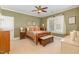 Comfortable bedroom featuring carpeted floors, wooden furnishings, and a bright window at 605 Bear Tree Crk, Chapel Hill, NC 27517