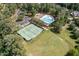 Aerial shot of community pool and tennis courts surrounded by mature trees at 605 Bear Tree Crk, Chapel Hill, NC 27517