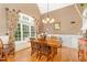 Elegant dining room with a large window, hardwood floors, and seating for six at 605 Bear Tree Crk, Chapel Hill, NC 27517