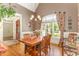 Dining room featuring a vaulted ceiling, arched window, and elegant curtains at 605 Bear Tree Crk, Chapel Hill, NC 27517