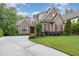 Charming two-story home with brick and stone exterior, red shutters, and a well-manicured lawn at 605 Bear Tree Crk, Chapel Hill, NC 27517
