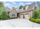Front exterior showcasing a two-car garage and manicured landscaping at 605 Bear Tree Crk, Chapel Hill, NC 27517