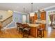 Gourmet kitchen island, stainless steel appliances, granite countertops, and seating for three at 605 Bear Tree Crk, Chapel Hill, NC 27517