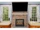 Cozy living room featuring a stone fireplace flanked by built-in window seats at 605 Bear Tree Crk, Chapel Hill, NC 27517