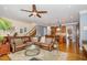 Open-concept living room with hardwood floors, ceiling fan and stairs to the upper level at 605 Bear Tree Crk, Chapel Hill, NC 27517