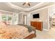 Spacious main bedroom with tray ceiling, walk-in closet, and access to a private balcony at 605 Bear Tree Crk, Chapel Hill, NC 27517