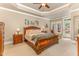 Serene bedroom with a tray ceiling, a king-sized bed, and access to an outdoor patio at 605 Bear Tree Crk, Chapel Hill, NC 27517