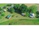Aerial view captures multiple structures, fields, and wooded areas on this rural property providing lots of possibilities at 623 Chambers Rd, Rougemont, NC 27572