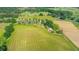 Aerial view showcasing a large tract of land and featuring a house, pond, and barn at 623 Chambers Rd, Rougemont, NC 27572