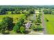 Aerial view featuring a pond, horse paddock, surrounding trees, and a long driveway at 623 Chambers Rd, Rougemont, NC 27572