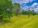 Spacious backyard featuring lush greenery, mature trees, with a peek of the pond, perfect for outdoor activities at 623 Chambers Rd, Rougemont, NC 27572