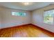 Bright bedroom featuring hardwood floors and ample natural light from two windows at 623 Chambers Rd, Rougemont, NC 27572