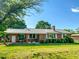 Well-maintained brick home with a metal roof, manicured lawn and established landscaping at 623 Chambers Rd, Rougemont, NC 27572