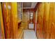 Hallway with wood paneling, storage cabinet, and access to additional rooms at 623 Chambers Rd, Rougemont, NC 27572