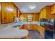 Traditional kitchen featuring wood cabinets, white countertops, and modern appliances at 623 Chambers Rd, Rougemont, NC 27572
