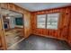 Inviting living room with wood-paneled walls and a view of the brick fireplace at 623 Chambers Rd, Rougemont, NC 27572