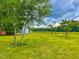 Expansive yard with mature trees, a shed, and glimpses of a red home and barn at 623 Chambers Rd, Rougemont, NC 27572