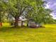 Expansive yard with mature trees and storage shed, great for outdoor activities at 623 Chambers Rd, Rougemont, NC 27572