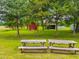 Tranquil yard featuring picnic tables and storage sheds, creating a peaceful outdoor space at 623 Chambers Rd, Rougemont, NC 27572