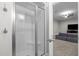 Modern bathroom featuring a glass-enclosed shower with a built-in seat and an adjacent carpeted living area at 6648 Mafolie Ct, Raleigh, NC 27613