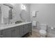 Elegant bathroom featuring a double vanity, modern fixtures, and a toilet at 6648 Mafolie Ct, Raleigh, NC 27613