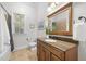 Traditional bathroom featuring a granite-topped vanity and a well-lit mirror at 6648 Mafolie Ct, Raleigh, NC 27613